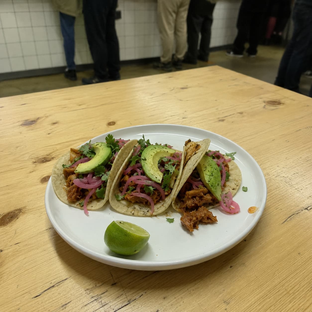 Mexican jackfruit tacos photographed on a phone against a cluttered table